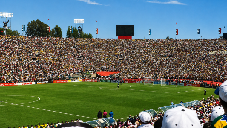 A packed stadium during the 1994 FIFA World Cup Final as players prepare for a decisive penalty kick, illustrating athlete nervous system regulation under extreme competitive pressure.