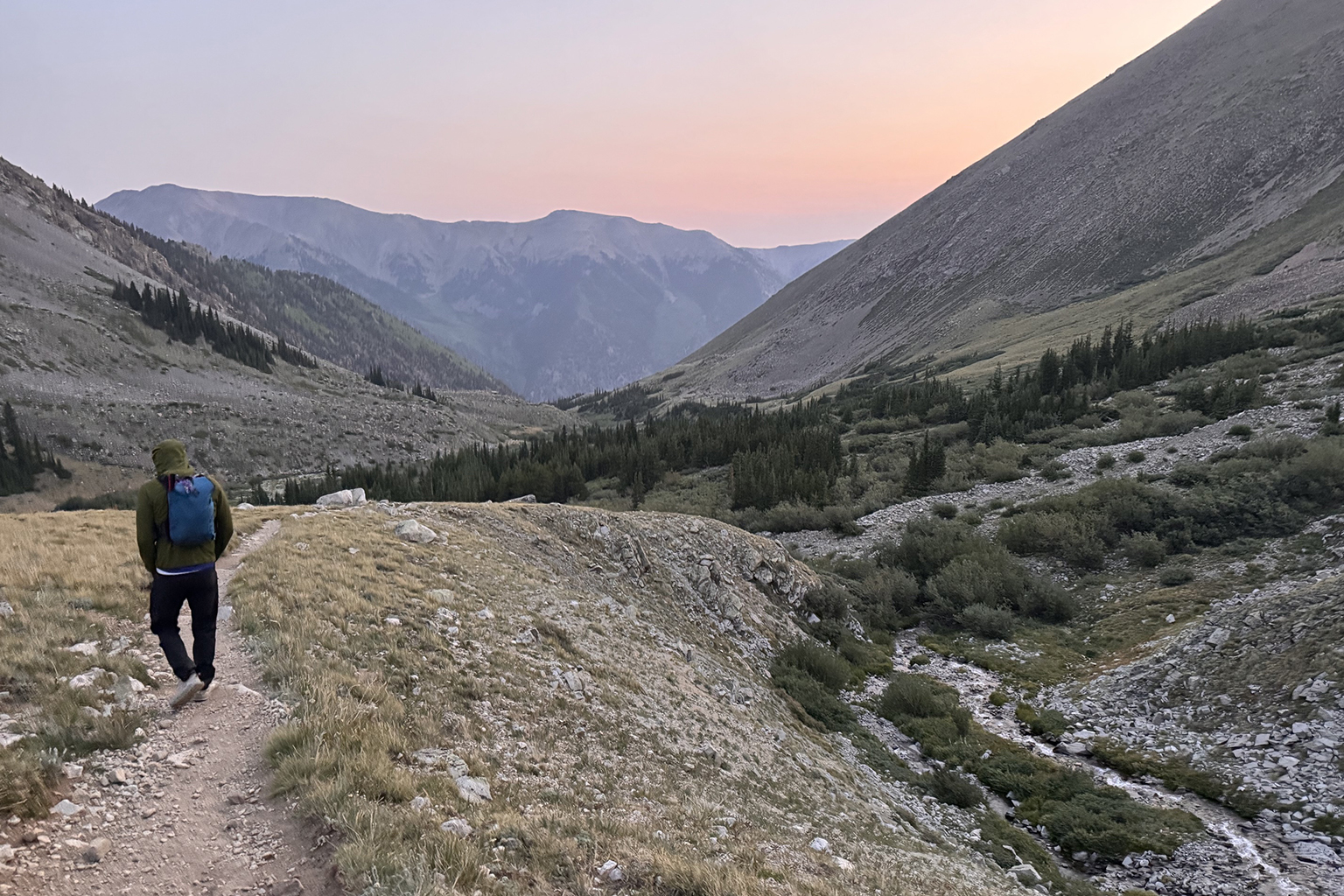 Athlete descending a mountain trail after turning back from a summit attempt, reflecting on doubt, memory, and nervous-system responses.